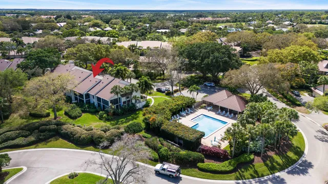 an aerial view of residential houses with outdoor space and trees