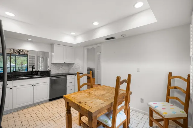 a kitchen with stainless steel appliances kitchen island granite countertop a sink and a stove top oven