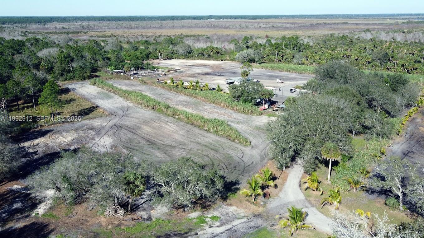 4850 Pioneer 2nd Street Clewiston, FL 33440 - Photo 31 of 34 a view of a big yard with mountain and trees in the background