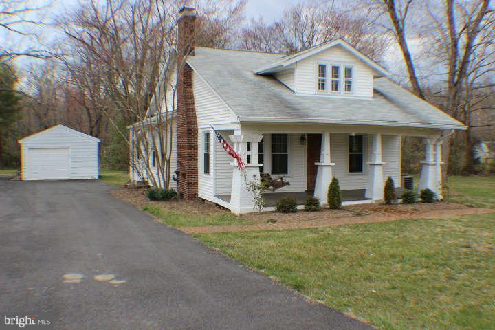 10304 Gunston Road Lorton, VA 22079 - Photo 1 of 30 a front view of a house with garden