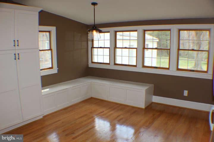 10304 Gunston Road Lorton, VA 22079 - Photo 13 of 30 a view of an empty room with wooden floor and a window