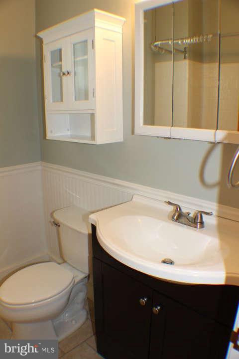 10304 Gunston Road Lorton, VA 22079 - Photo 16 of 30 a bathroom with a sink toilet and mirror
