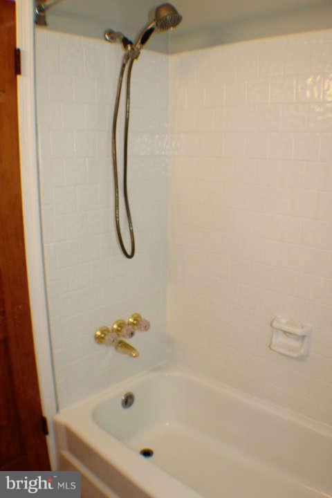 10304 Gunston Road Lorton, VA 22079 - Photo 17 of 30 a bathroom with a bath tub and a shower