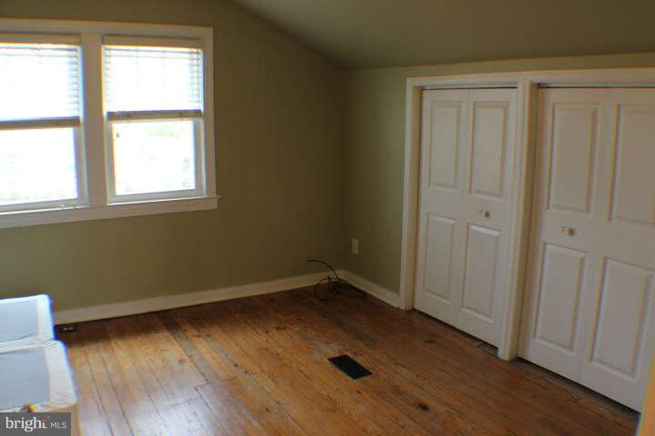 10304 Gunston Road Lorton, VA 22079 - Photo 19 of 30 an empty room with wooden floor and windows