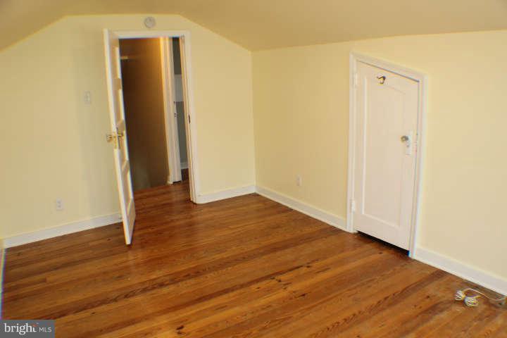 10304 Gunston Road Lorton, VA 22079 - Photo 21 of 30 an empty room with wooden floor and entrance