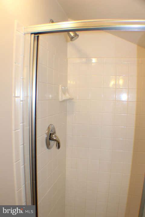 10304 Gunston Road Lorton, VA 22079 - Photo 24 of 30 a bathroom with a glass shower door