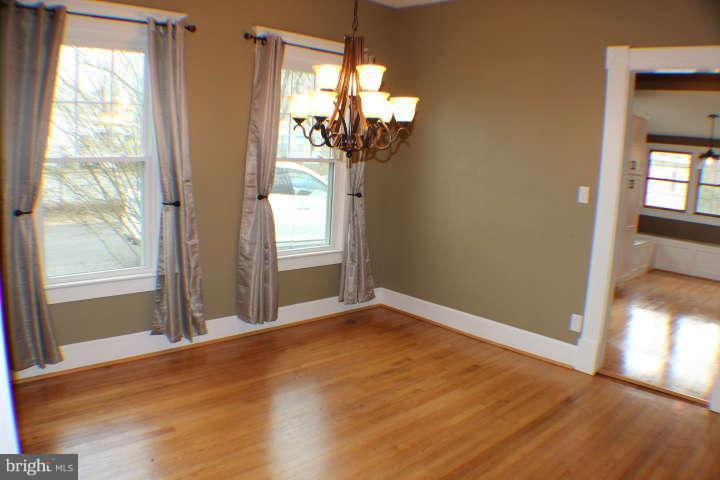 10304 Gunston Road Lorton, VA 22079 - Photo 9 of 30 a view of empty room with wooden floor and fan
