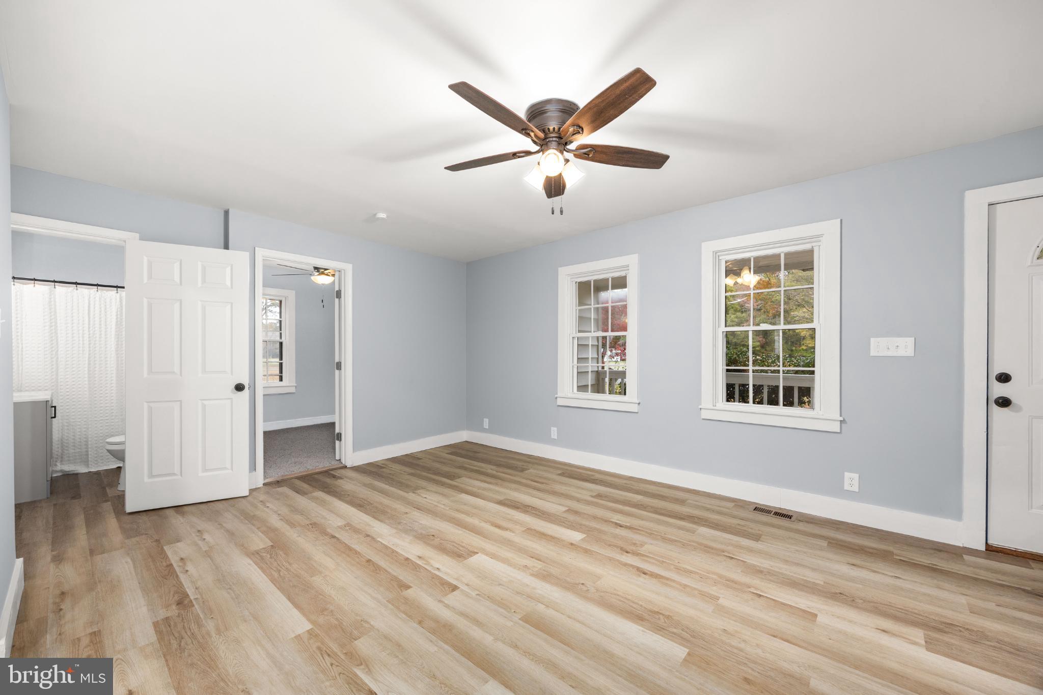 28766 Larry Lankford Road Princess Anne, MD 21853 - Photo 14 of 38 a view of an empty room with wooden floor and a window