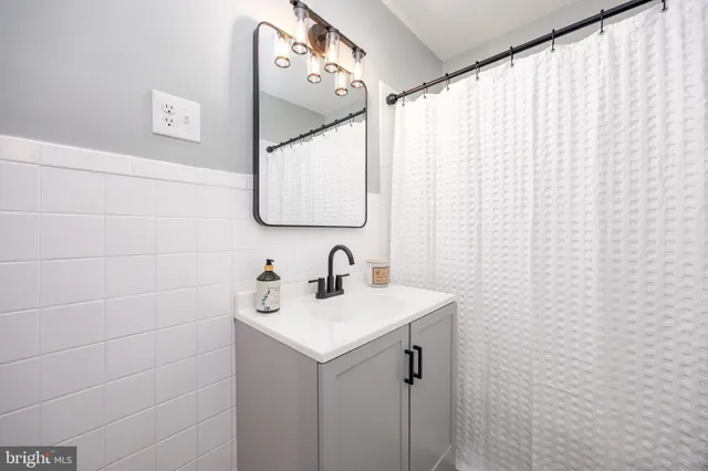 a bathroom with a sink vanity and a mirror