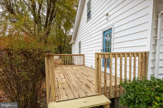 a view of a balcony with wooden floor and fence
