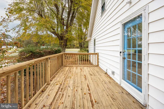 a view of balcony with wooden floor and fence