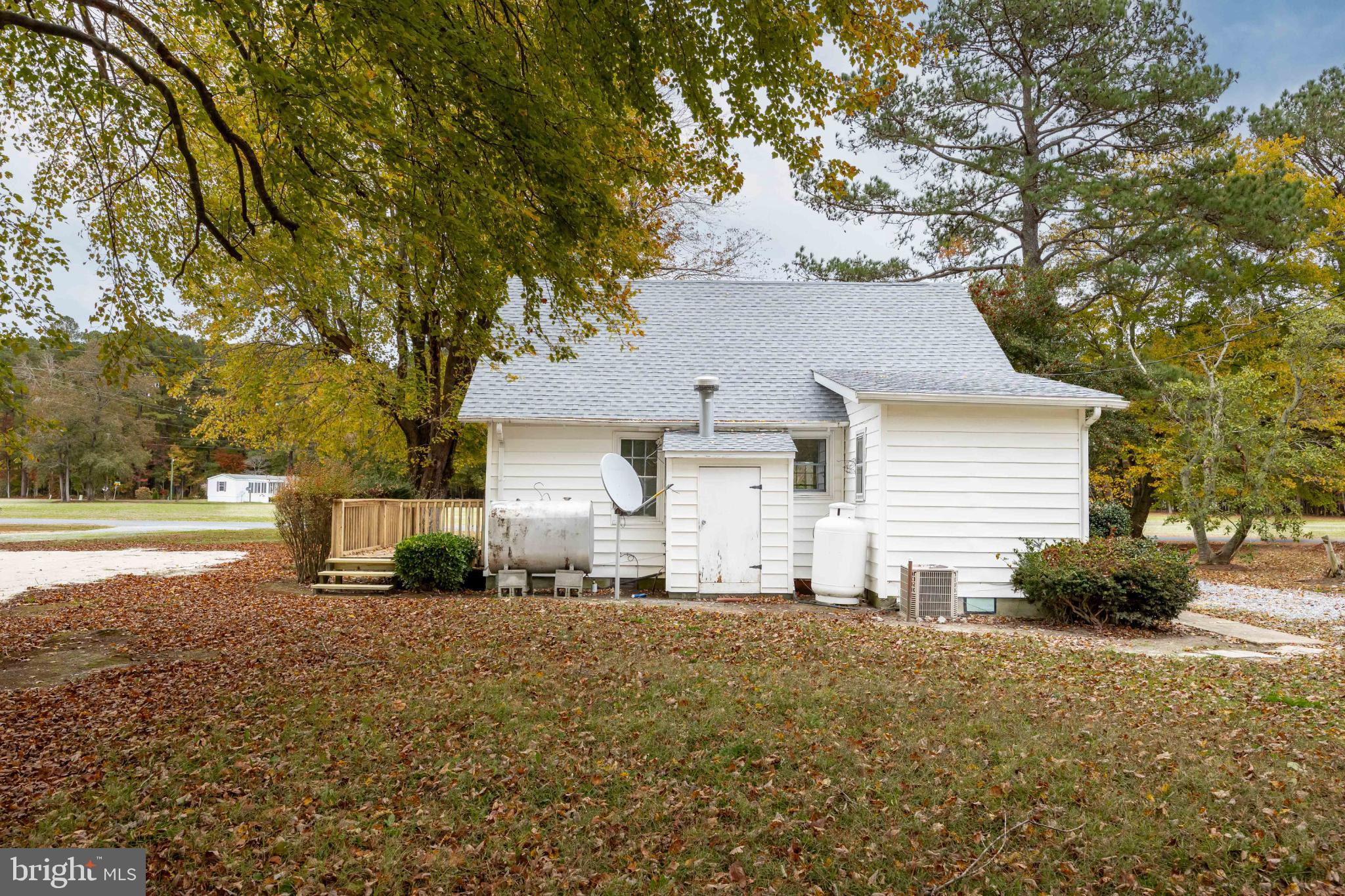 28766 Larry Lankford Road Princess Anne, MD 21853 - Photo 36 of 38 a front view of a house with a yard and garage