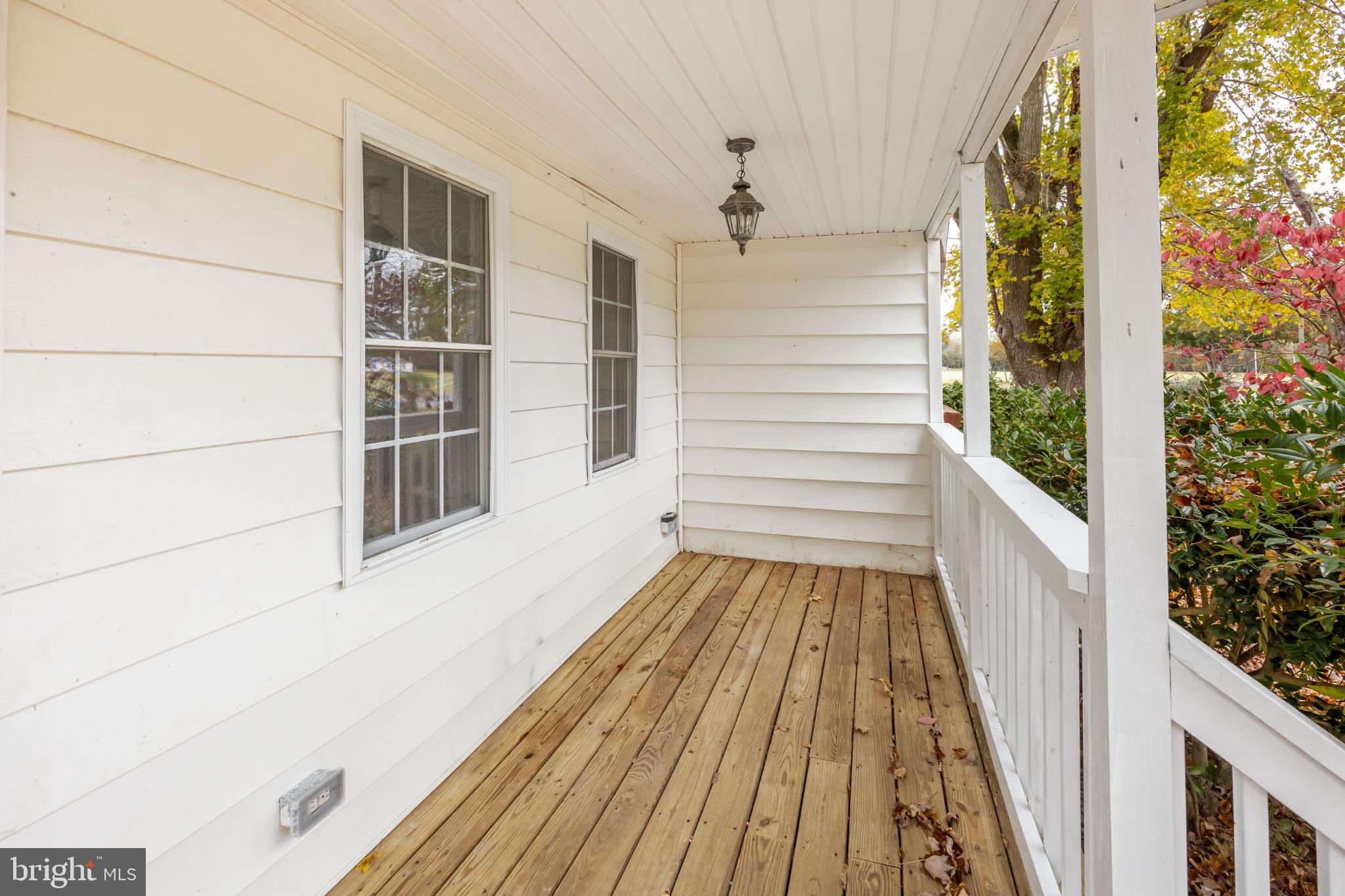 28766 Larry Lankford Road Princess Anne, MD 21853 - Photo 4 of 38 a view of a balcony with wooden floor and white walls