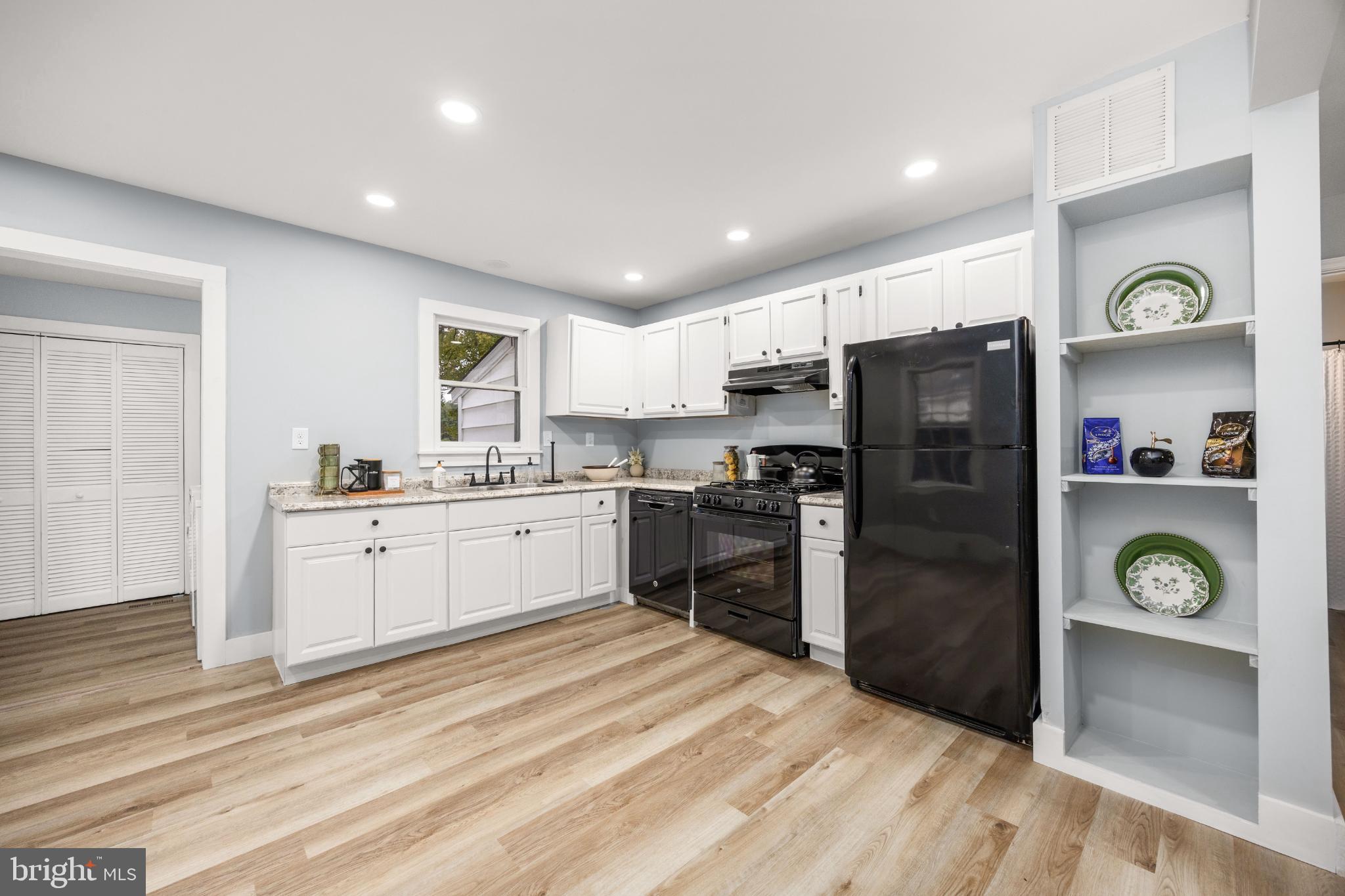 28766 Larry Lankford Road Princess Anne, MD 21853 - Photo 7 of 38 a kitchen with granite countertop a refrigerator and a stove top oven
