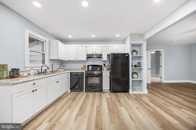a kitchen with stainless steel appliances granite countertop a refrigerator and a sink