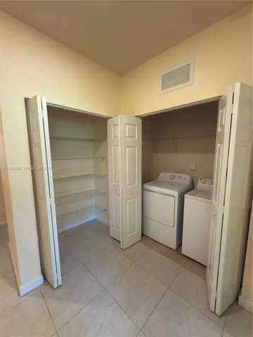 a bathroom with a sink a toilet a mirror and shower