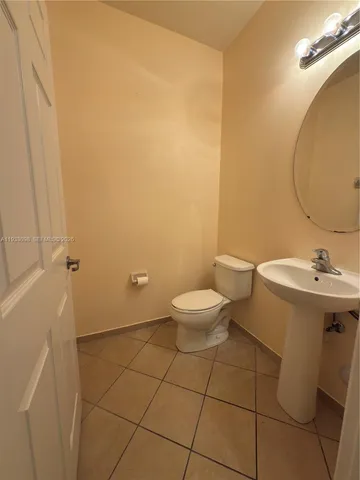 an empty room with a window and a ceiling fan