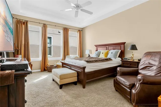 a bedroom with a bed and a chandelier