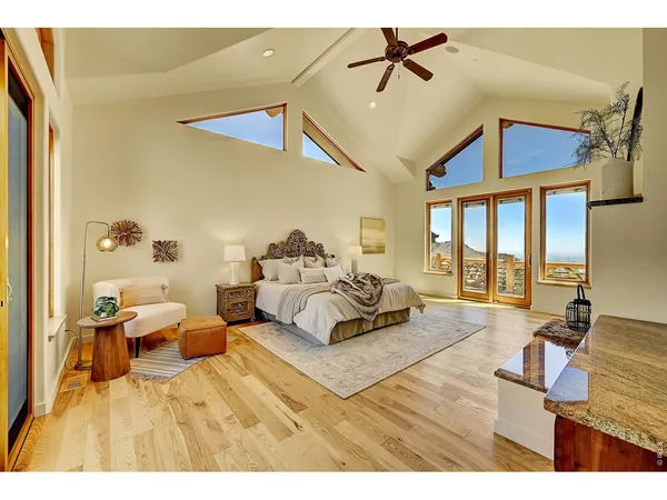 a spacious bedroom with a bed and wooden floor