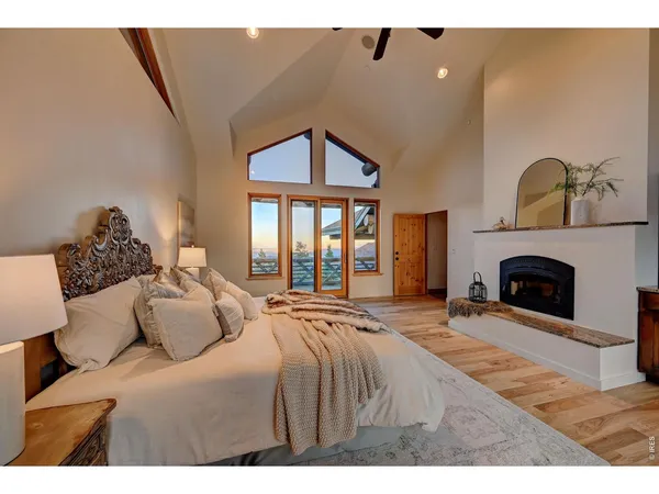 a spacious bedroom with a bed and a fireplace