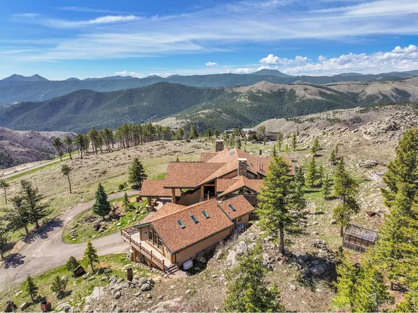 an aerial view of a house with mountain view