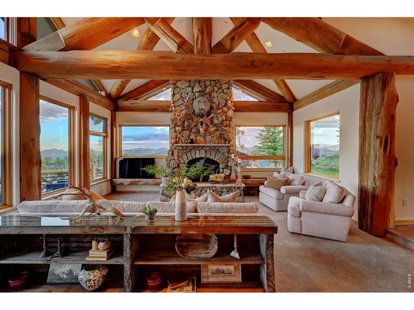 a living room with furniture a fireplace and a chandelier