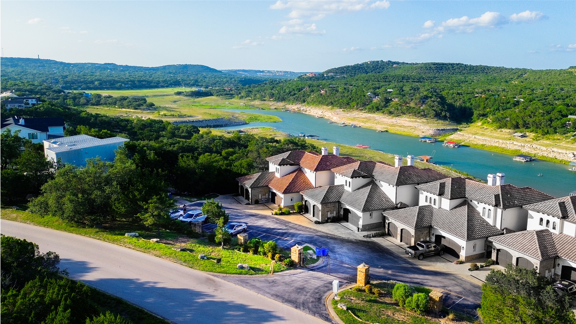 an aerial view of a house with a garden and lake view