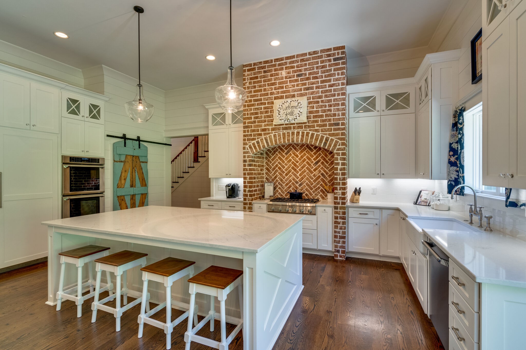 1453 Sneed Road West Franklin, TN 37069 - Photo 23 of 50 a kitchen with sink cabinets and wooden floor