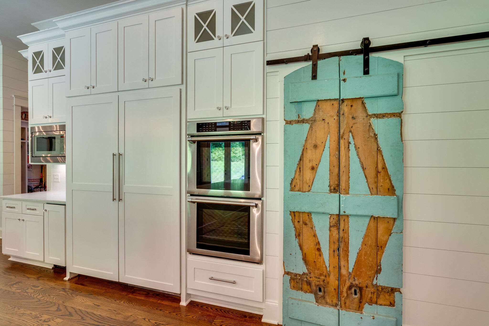 1453 Sneed Road West Franklin, TN 37069 - Photo 26 of 50 a room with wooden floor and cabinets