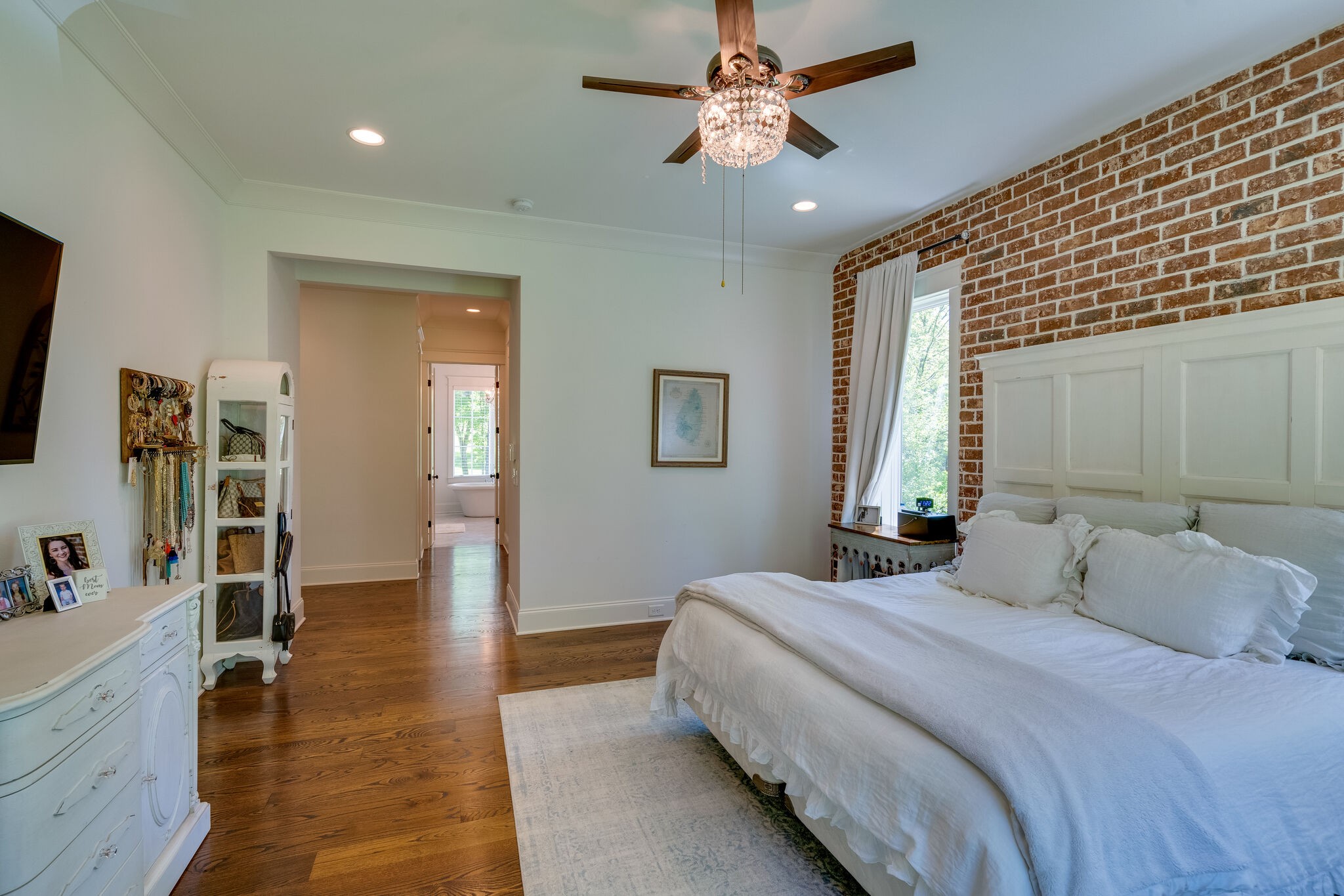 1453 Sneed Road West Franklin, TN 37069 - Photo 28 of 50 a bedroom with a large bed and a chandelier