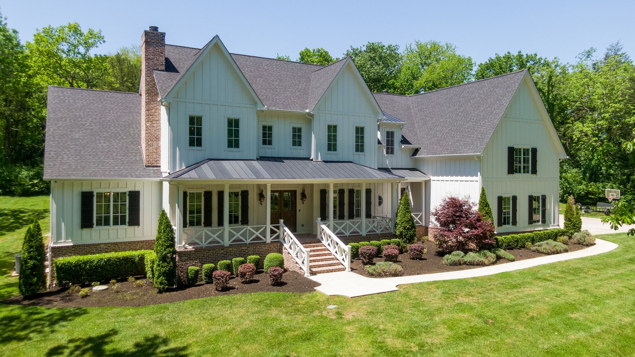 1453 Sneed Road West Franklin, TN 37069 - Photo 4 of 50 a front view of a house with a yard table and chairs