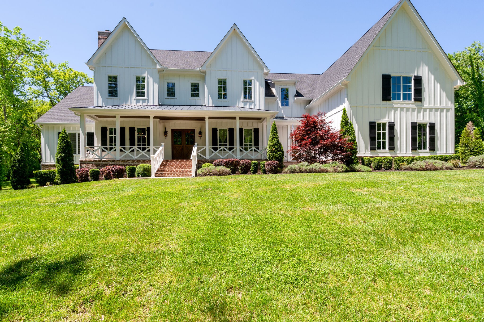 1453 Sneed Road West Franklin, TN 37069 - Photo 5 of 50 a front view of a house with a yard table and chairs