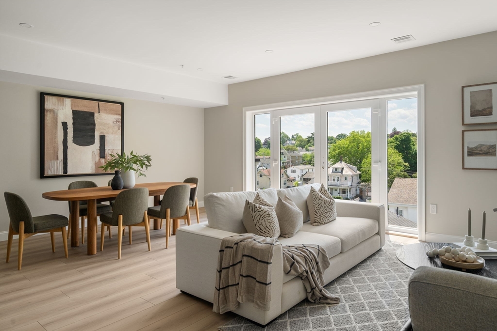 13 Wentworth Road, Unit 404 Quincy, MA 02170 - Photo 1 of 18 a living room with furniture and a large window