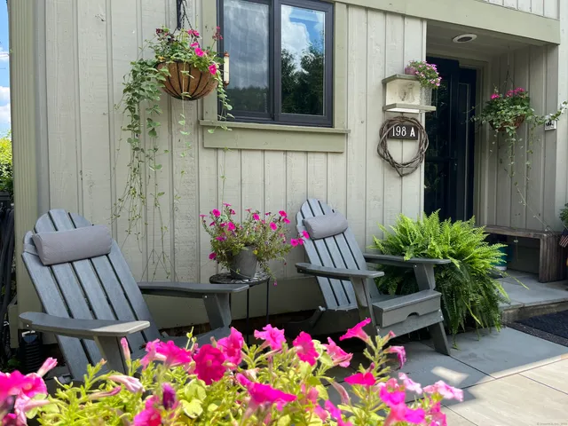 a front view of a house with flowers