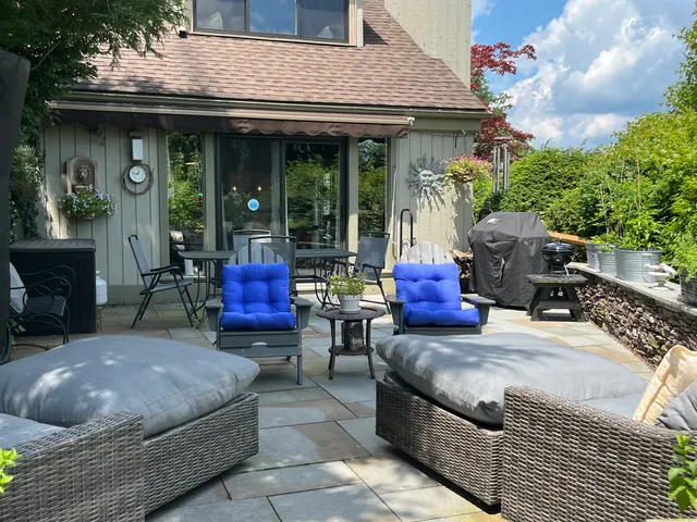 a building outdoor space with patio furniture and potted plants