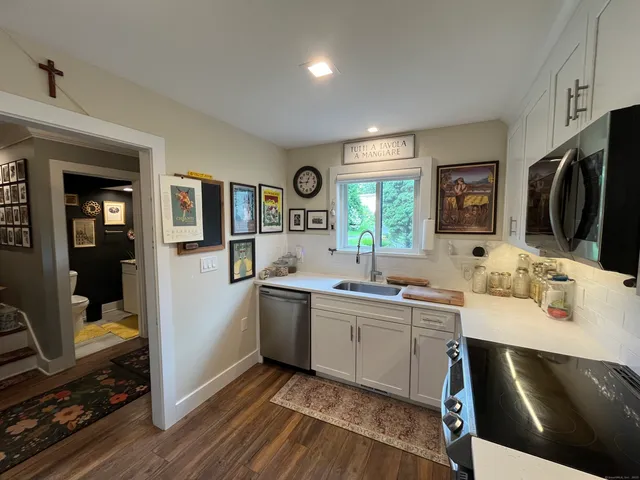 a view of a kitchen sink and a window