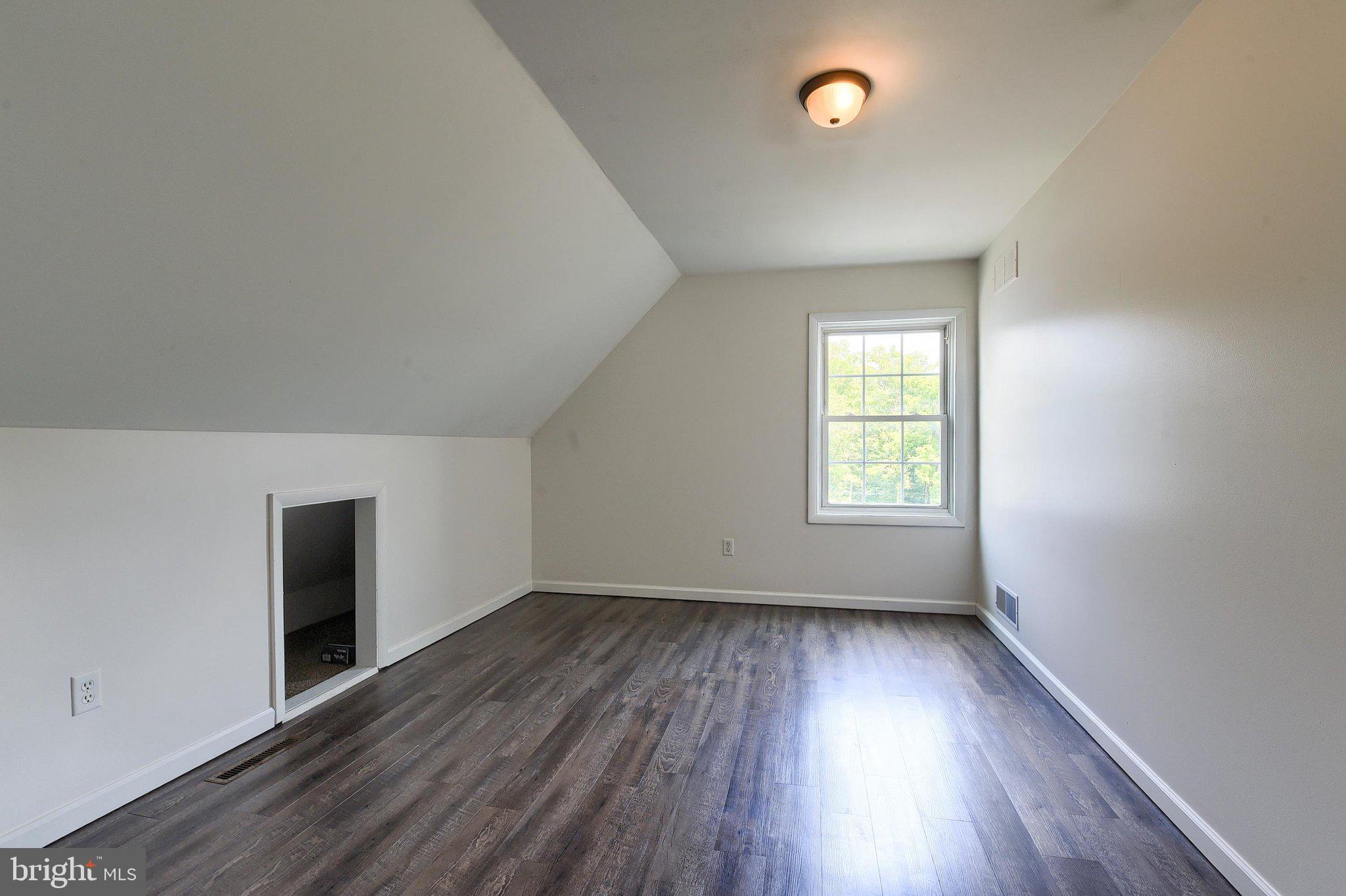 3740 Beagle Road Middletown, PA 17057 - Photo 19 of 70 an empty room with wooden floor and windows