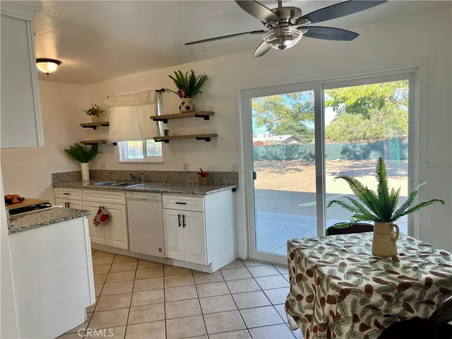 a kitchen with stainless steel appliances granite countertop a stove a sink and a chandelier