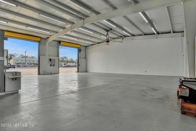 a view of a shop with furniture and a garage