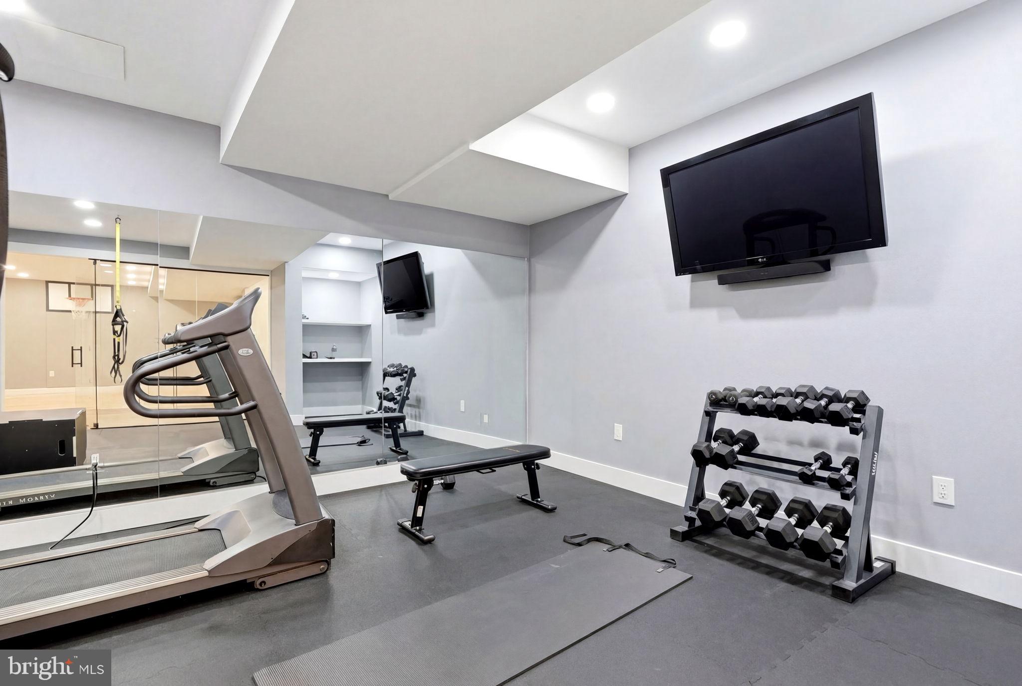 7 Woodland Road Newtown, PA 18940 - Photo 112 of 137 a room with gym equipment and a flat screen tv