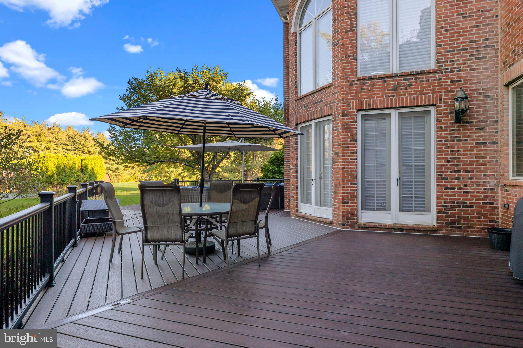 7 Woodland Road Newtown, PA 18940 - Photo 121 of 137 a view of a roof deck with table and chairs a barbeque with wooden floor and fence