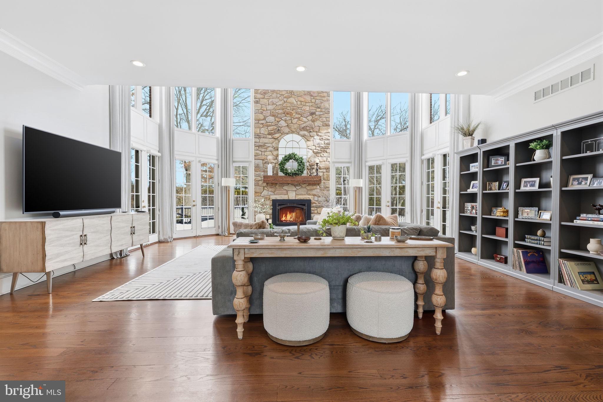 7 Woodland Road Newtown, PA 18940 - Photo 31 of 137 a living room with furniture a flat screen tv and floor to ceiling window