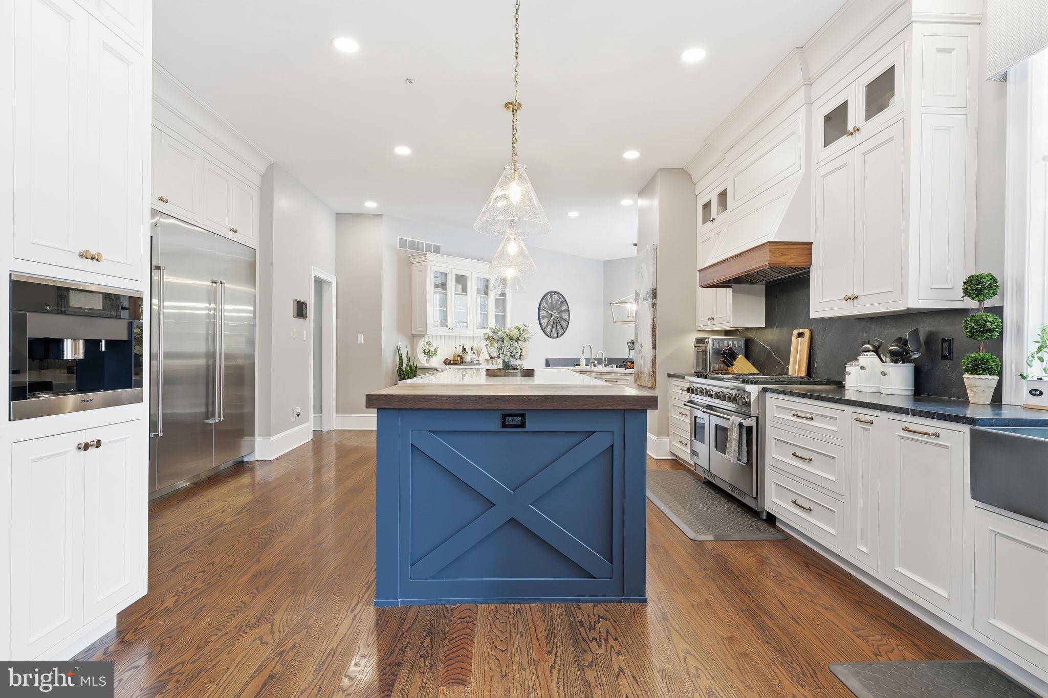 7 Woodland Road Newtown, PA 18940 - Photo 34 of 137 a large kitchen with stainless steel appliances kitchen island granite countertop a stove a sink a refrigerator and a white cabinets with wooden floor