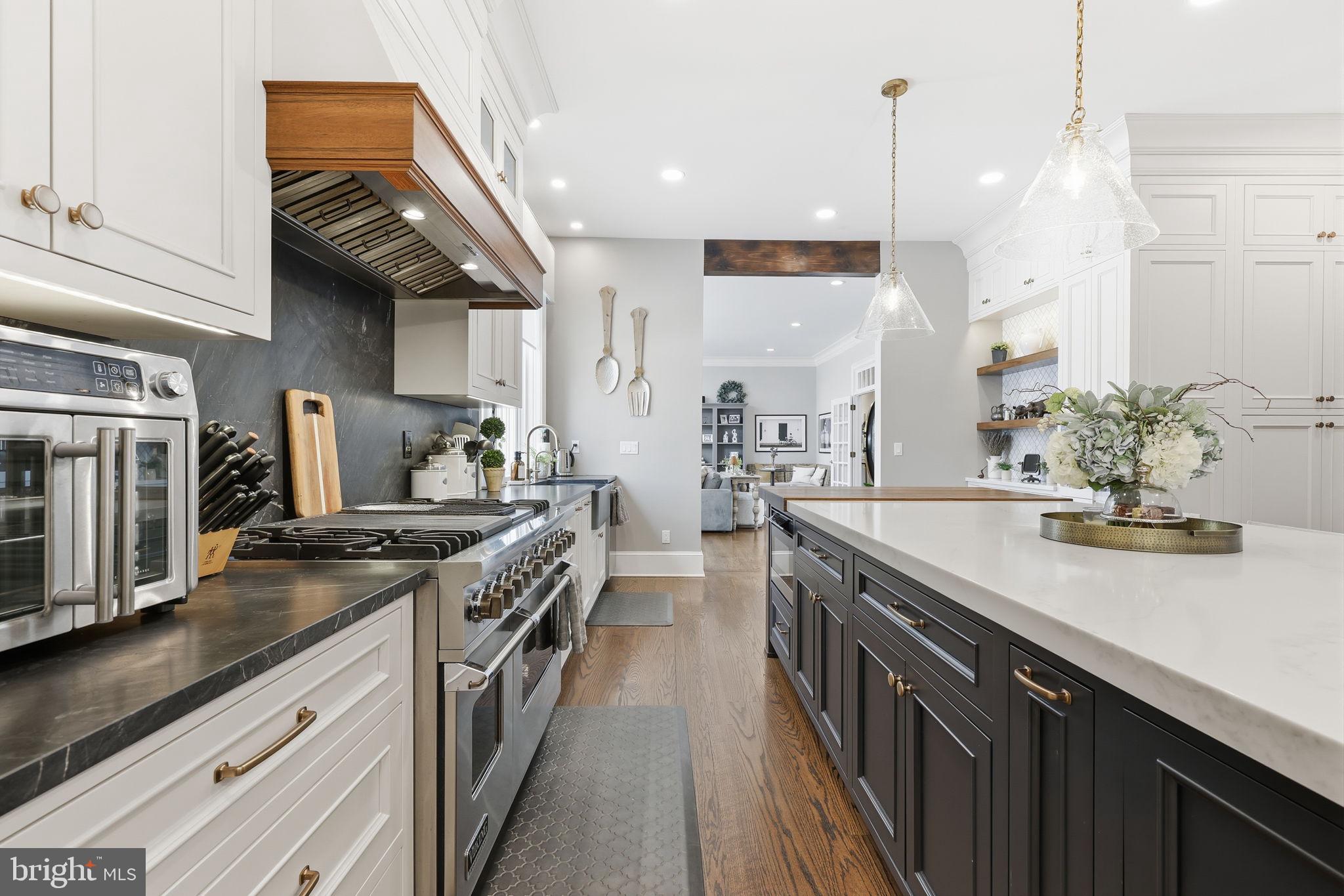 7 Woodland Road Newtown, PA 18940 - Photo 37 of 137 a kitchen with stainless steel appliances granite countertop a sink a stove and a wooden floors
