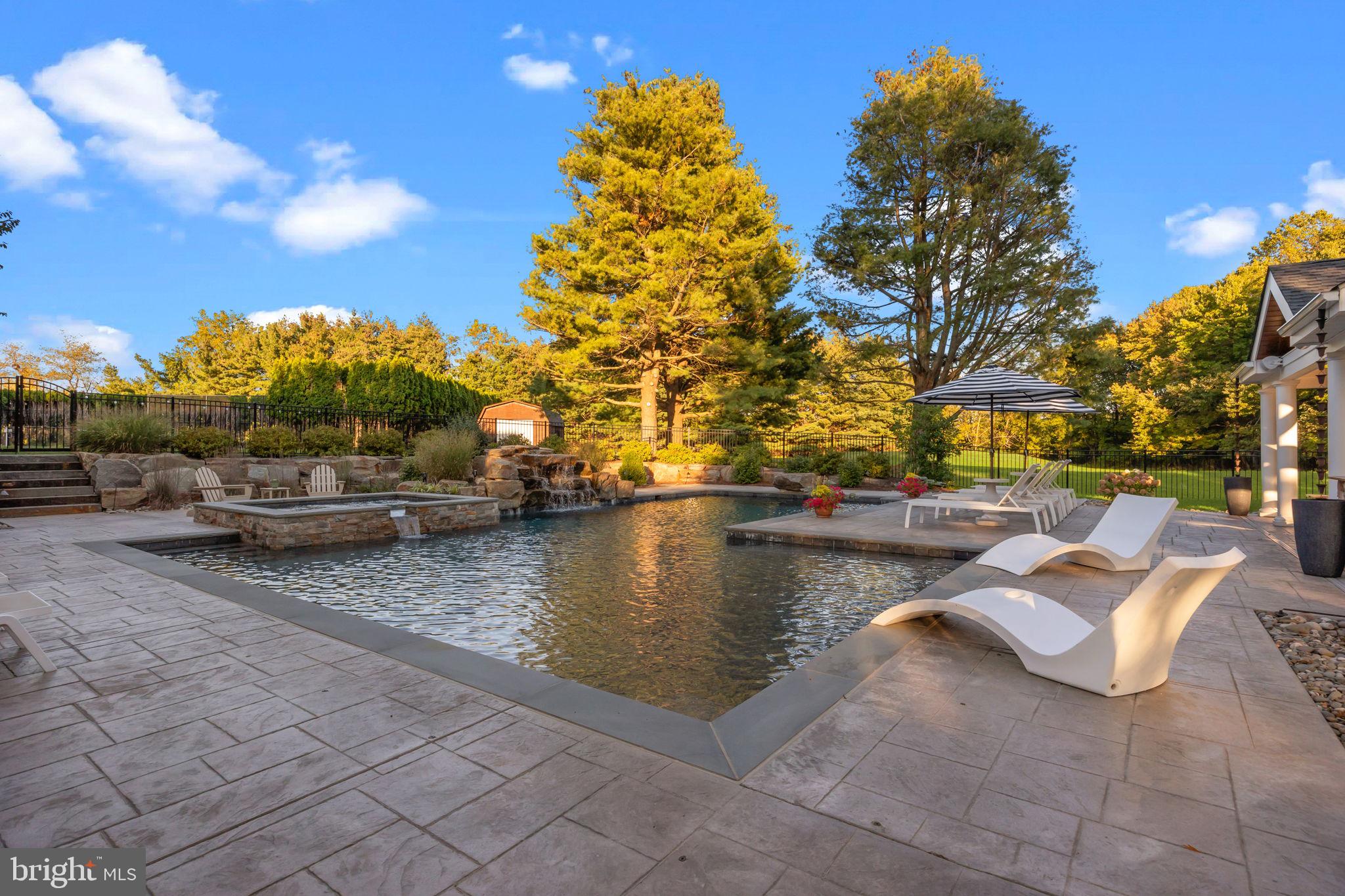 7 Woodland Road Newtown, PA 18940 - Photo 6 of 137 a view of swimming pool with outdoor seating and plants