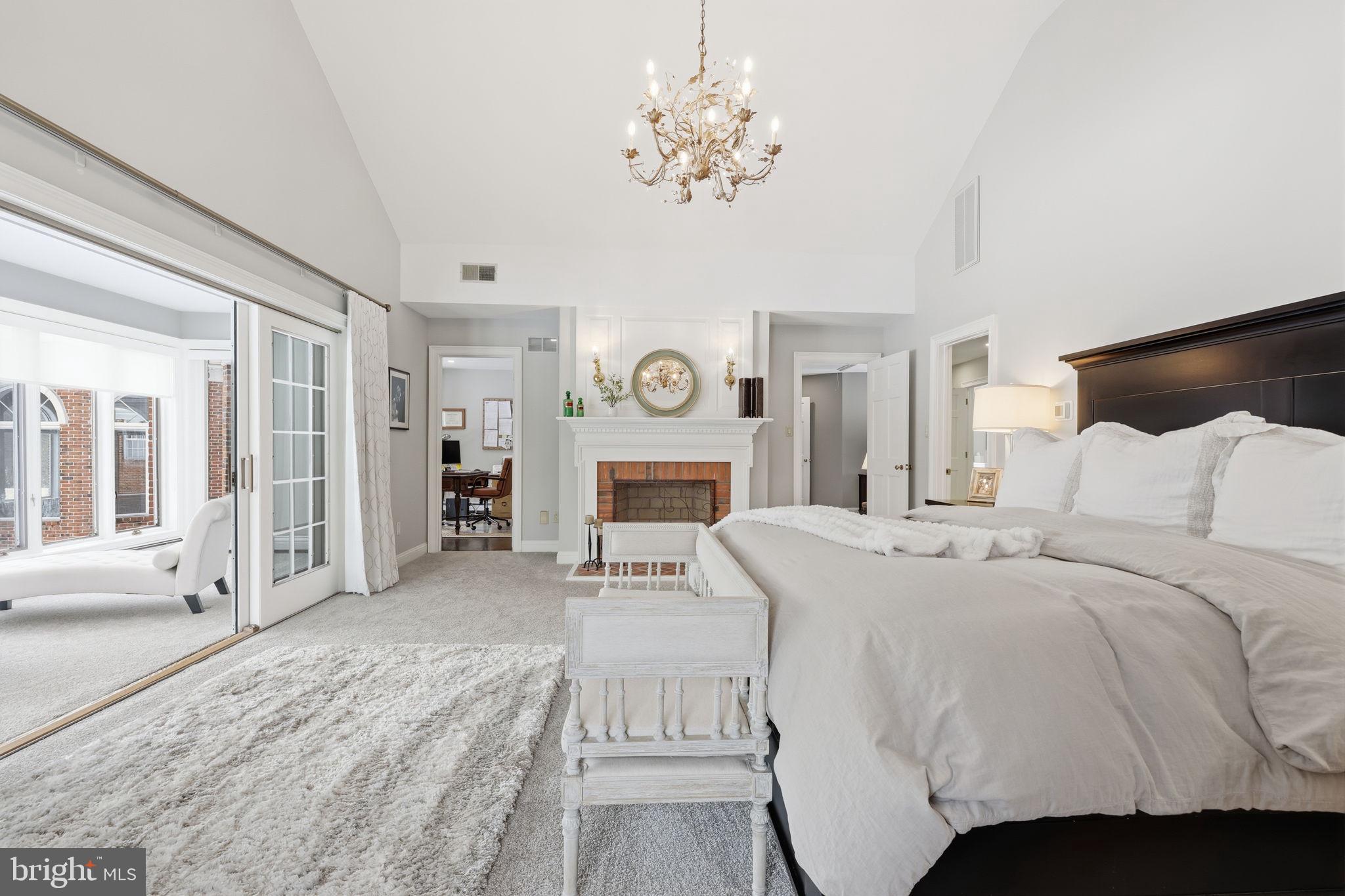 7 Woodland Road Newtown, PA 18940 - Photo 65 of 137 a spacious bedroom with a bed and a chandelier