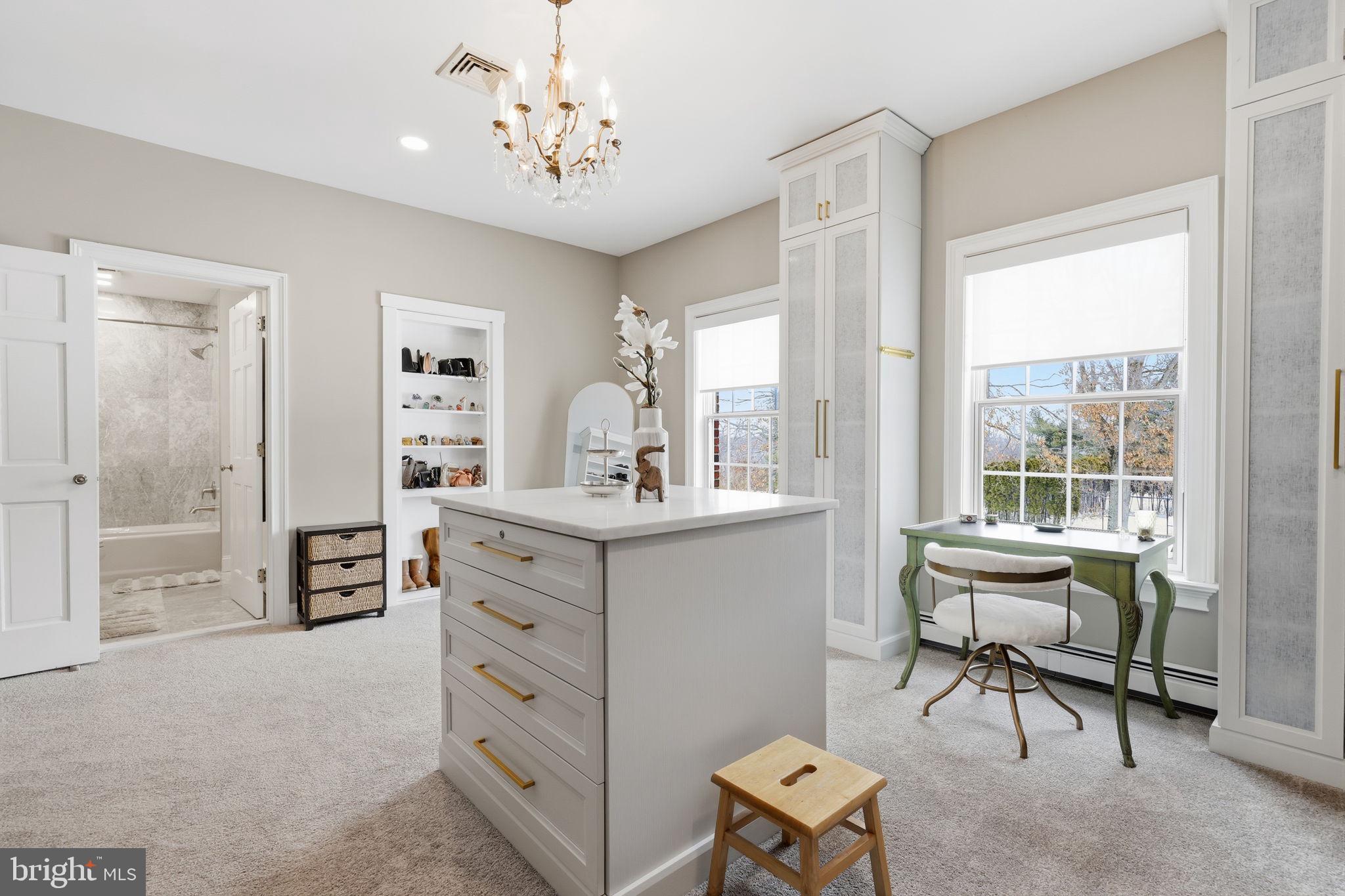 7 Woodland Road Newtown, PA 18940 - Photo 77 of 137 a spacious bedroom with a bed and a chair in it