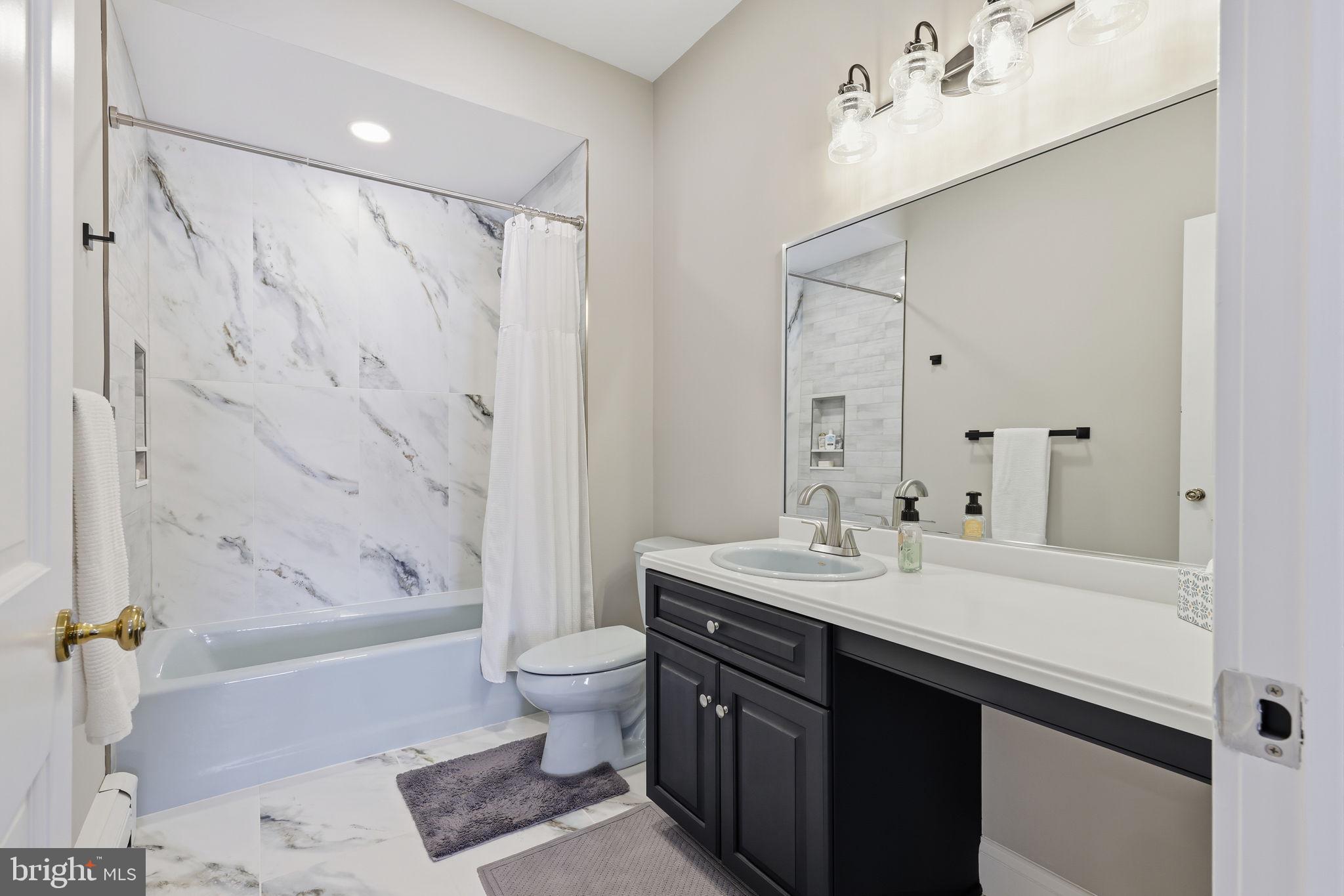 7 Woodland Road Newtown, PA 18940 - Photo 88 of 137 a bathroom with a double vanity sink toilet mirror and bathtub