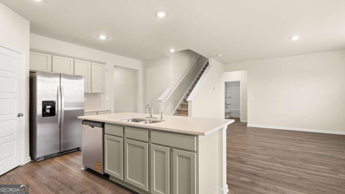 208 Cattle Drive Perry, GA 31069 - Photo 12 of 37 a kitchen with stainless steel appliances a sink and a refrigerator