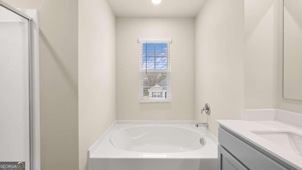 208 Cattle Drive Perry, GA 31069 - Photo 18 of 37 a white bath tub sitting next to a white sink